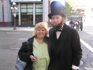 Connie Wilson posing with man dressed as Abraham Lincoln