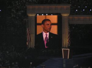 Barack Obama on large screen at Invesco